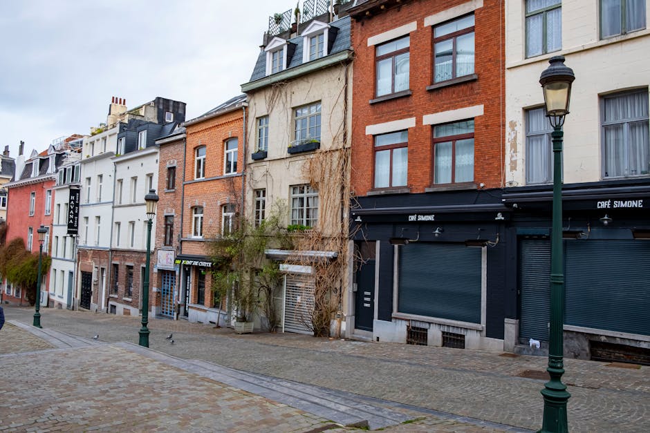 Cobblestone street lined with historic European houses near Brussels Grand Place