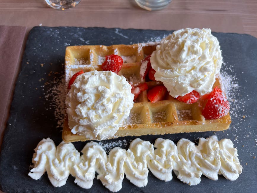 Best waffles in Brussels — mouth-watering Belgian waffle topped with fresh strawberries and whipped cream