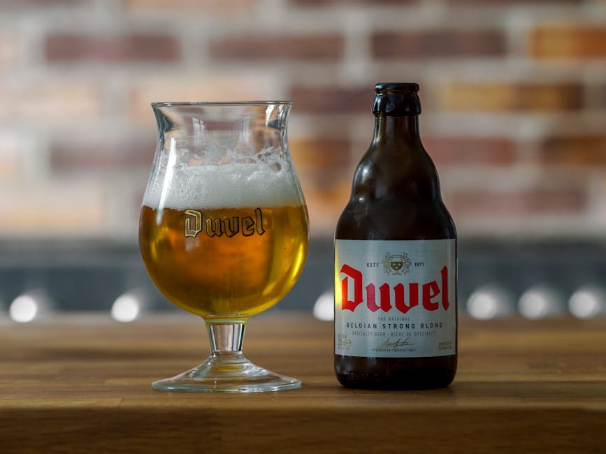 Belgian beer guide Brussels — Belgian beer bottle and chalice glass on wooden table in pub setting