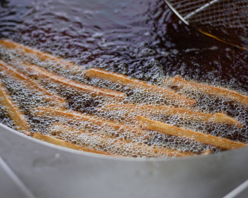 Best frites in Brussels — close-up of French fries being deep-fried in hot oil