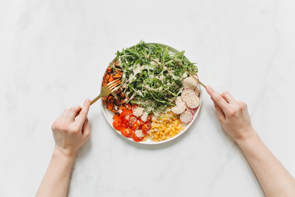 Vegan restaurants in Brussels — colourful nutritious vegetable salad with hands holding forks