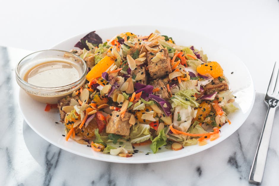 Vegan restaurants in Brussels — fresh vegan tofu salad with orange slices and almonds in white bowl