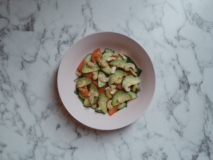 Vegan restaurants in Brussels — delicious vegan salad with cucumbers tomatoes and nuts in ceramic bowl