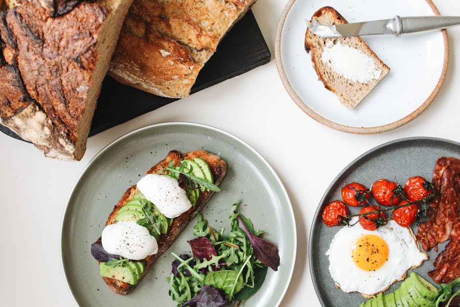 Best brunch in Brussels — vibrant breakfast table featuring avocado toast eggs and fresh tomatoes