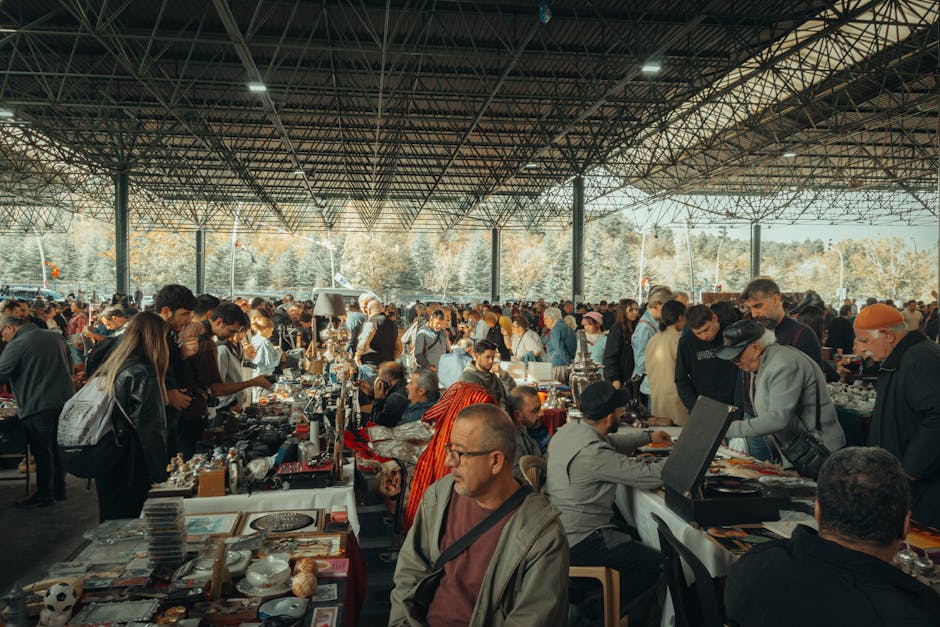 Marolles Brussels guide — bustling flea market with diverse crowd under metal canopy showcasing various vintage goods