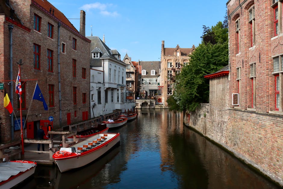 Bruges day trip from Brussels — best scenic view of canal in Bruges with moored boats and historic buildings