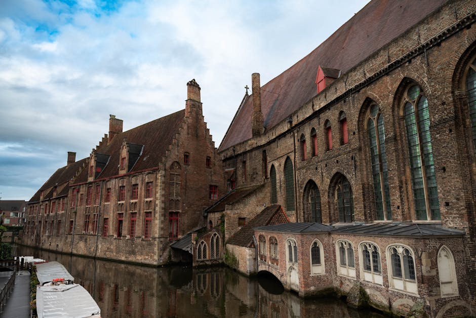 Bruges day trip from Brussels — best historic brick buildings along tranquil canal in Bruges Belgium