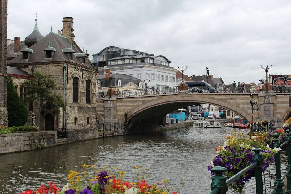 Ghent day trip from Brussels — best charming canal in Ghent Belgium with historic bridge flowers and classical buildings
