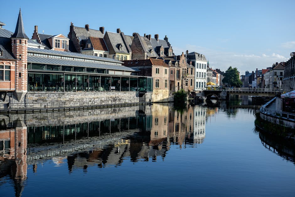 Ghent day trip from Brussels — best reflection of historic buildings along canal in Ghent Belgium Graslei quay