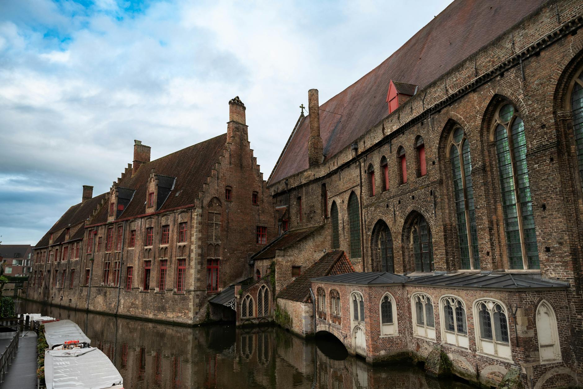 Bruges canal with medieval brick buildings and reflections in Belgium