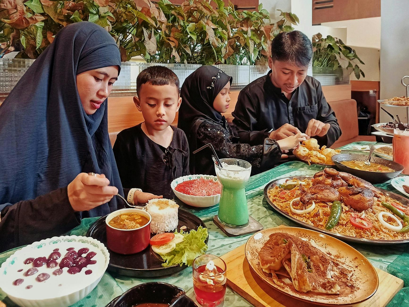 Family with children enjoying a meal together at a restaurant