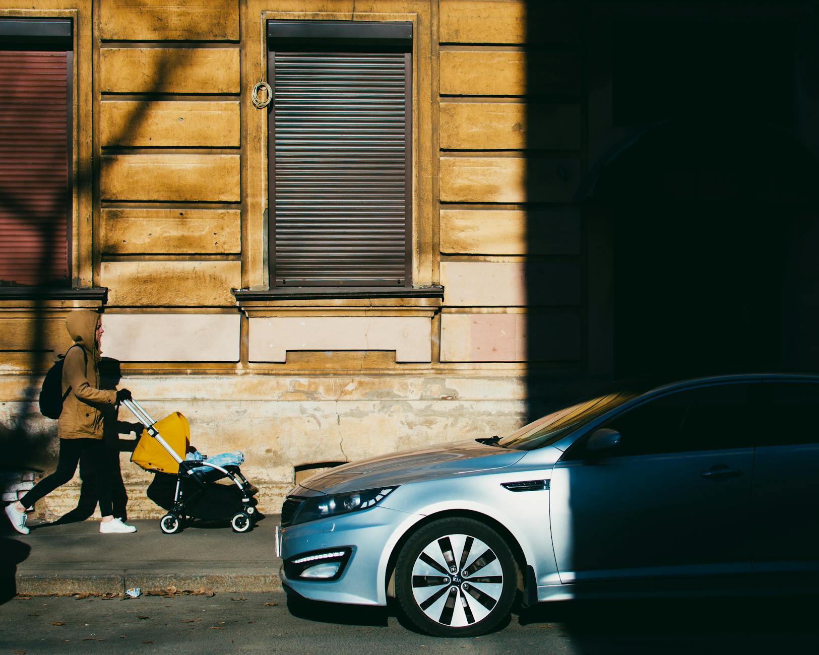 Family with stroller walking through a European city street