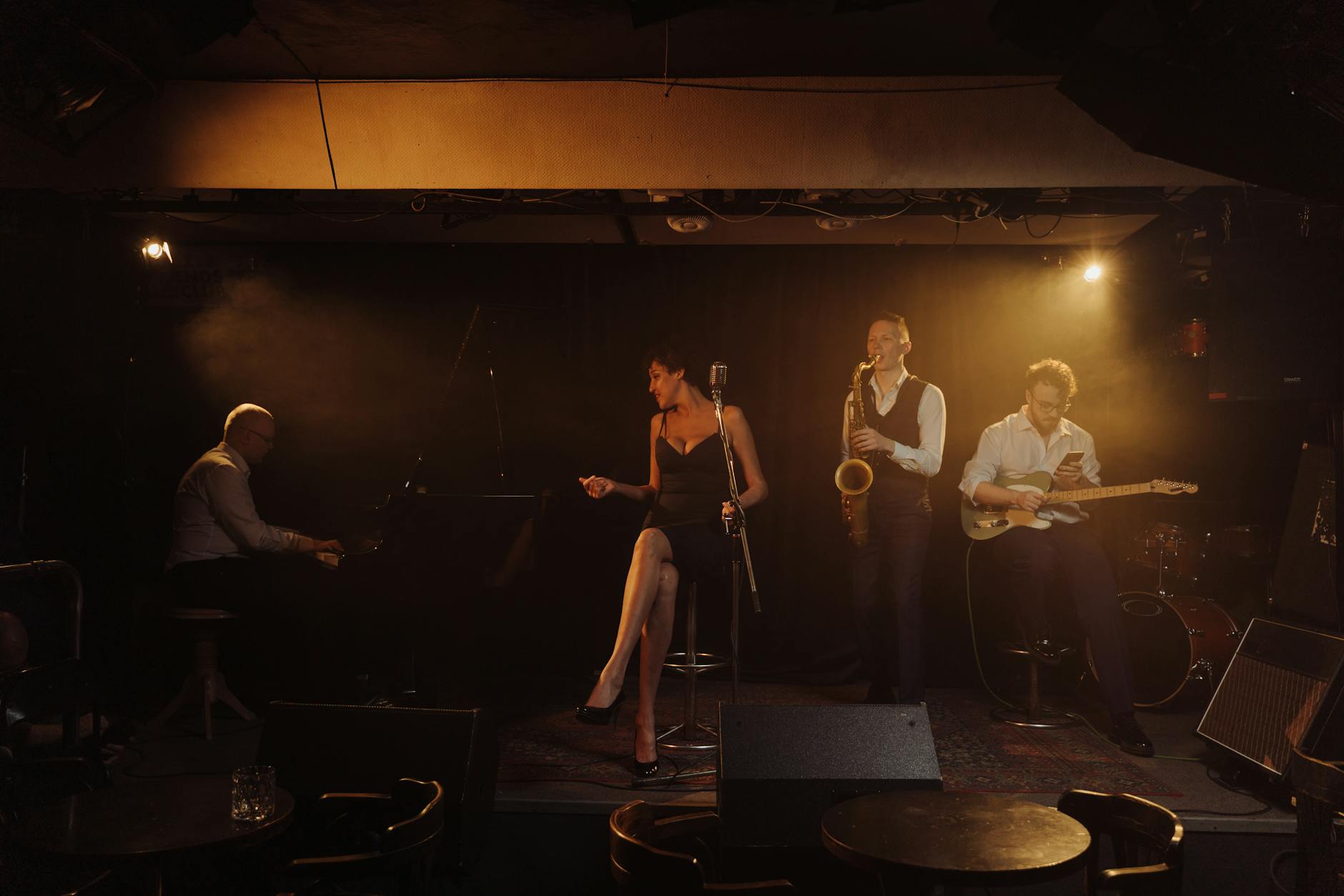 Live jazz performance in an intimate club setting with musicians on stage