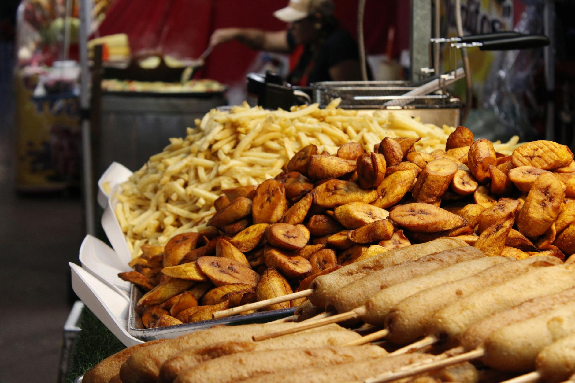 Belgian fries being served at a street food stall at night