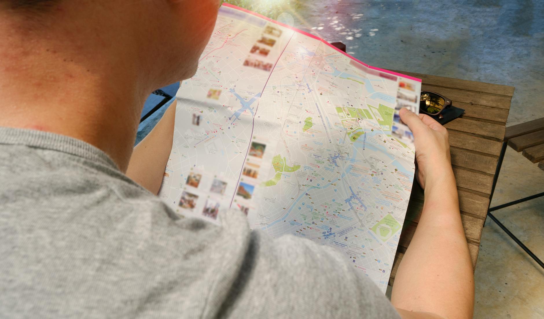 A tourist studying a map while walking through a European city