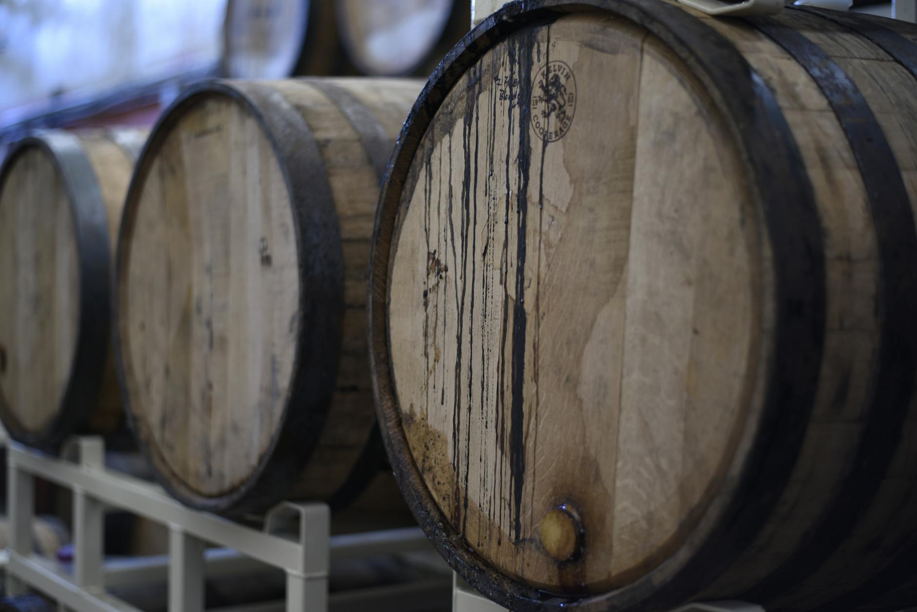 Traditional wooden barrels aging lambic beer in a historic Brussels brewery