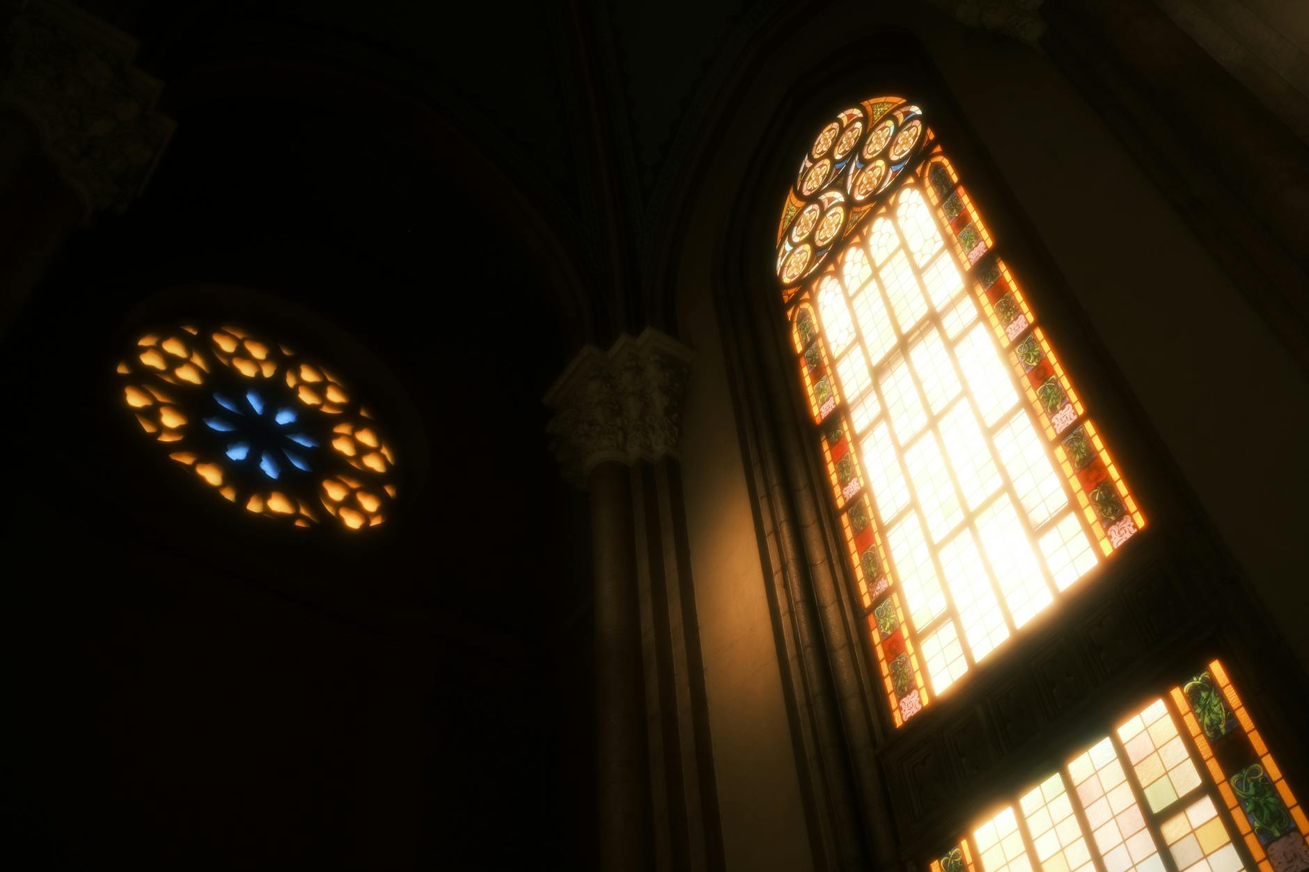Stunning stained glass windows casting coloured light inside a Gothic cathedral