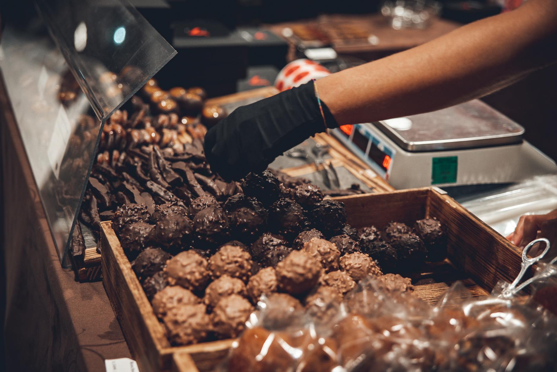 Hands making artisan chocolate truffles at a workshop