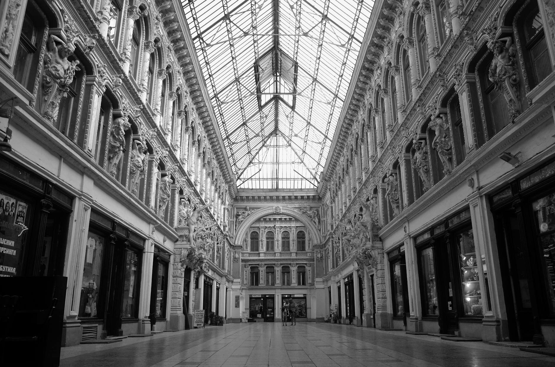 An elegant covered shopping arcade with a glass ceiling