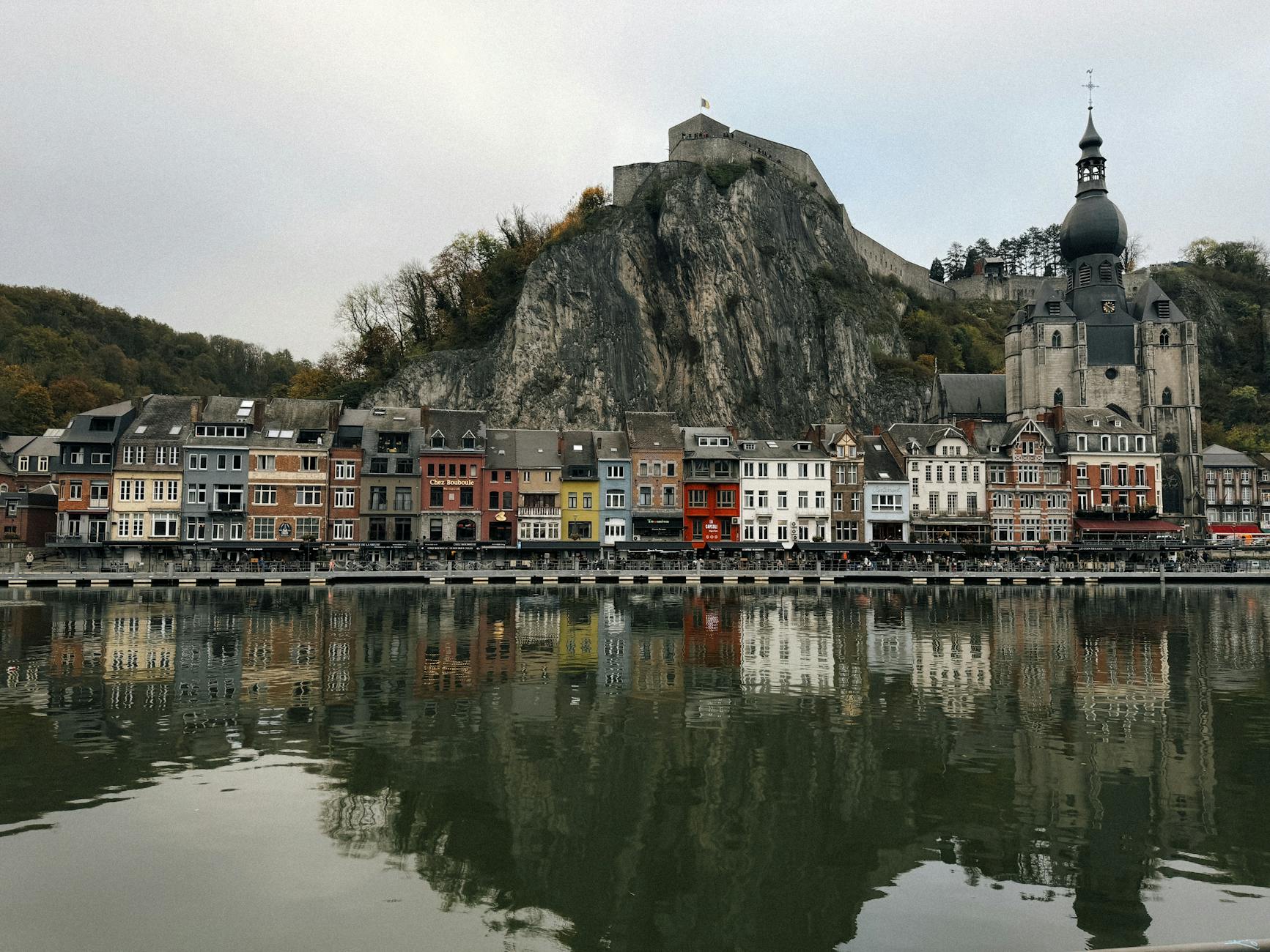 Dinant Belgium colourful houses along the Meuse River with citadel and church