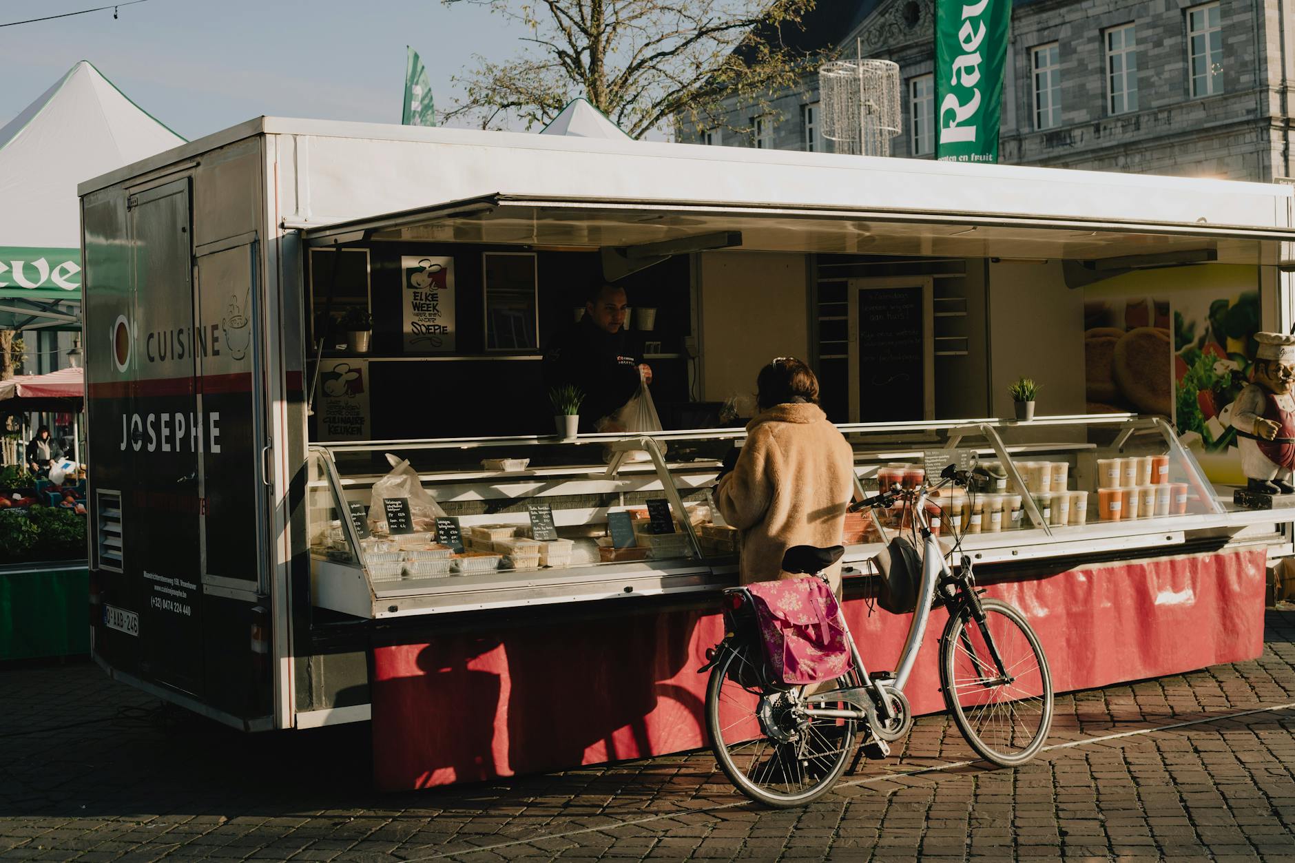 A lively outdoor food market in a Brussels neighbourhood square