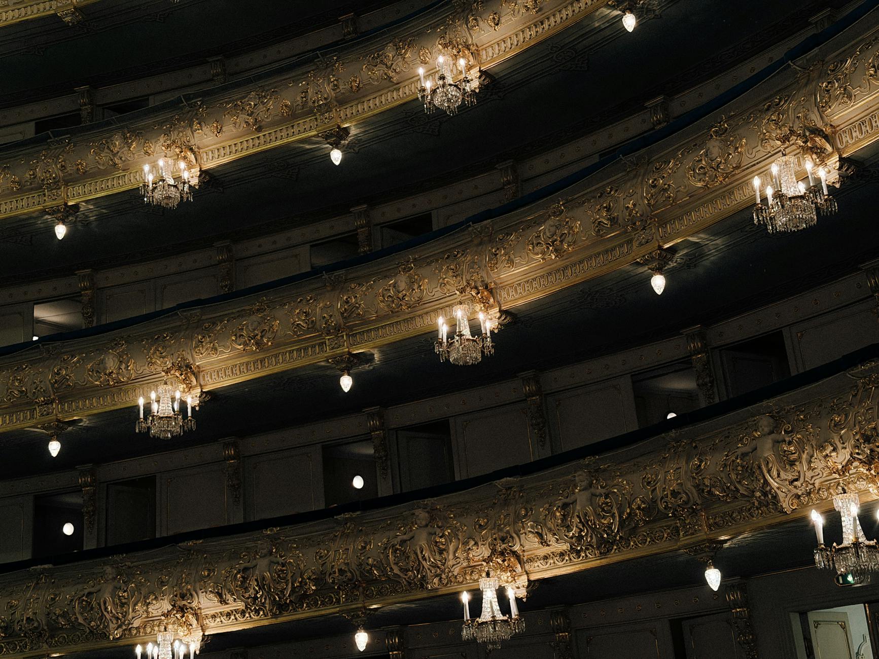 An elegant opera house interior with chandelier and ornate decorations