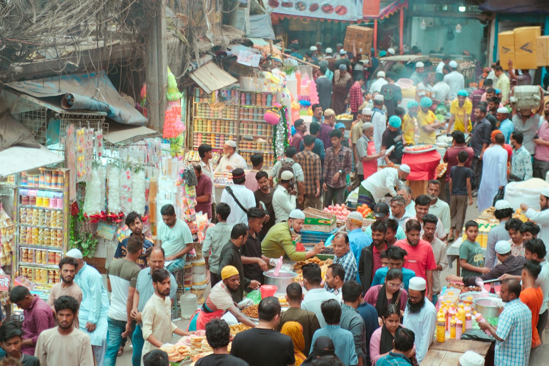 A bustling open-air Sunday market with diverse food stalls near Brussels Midi station