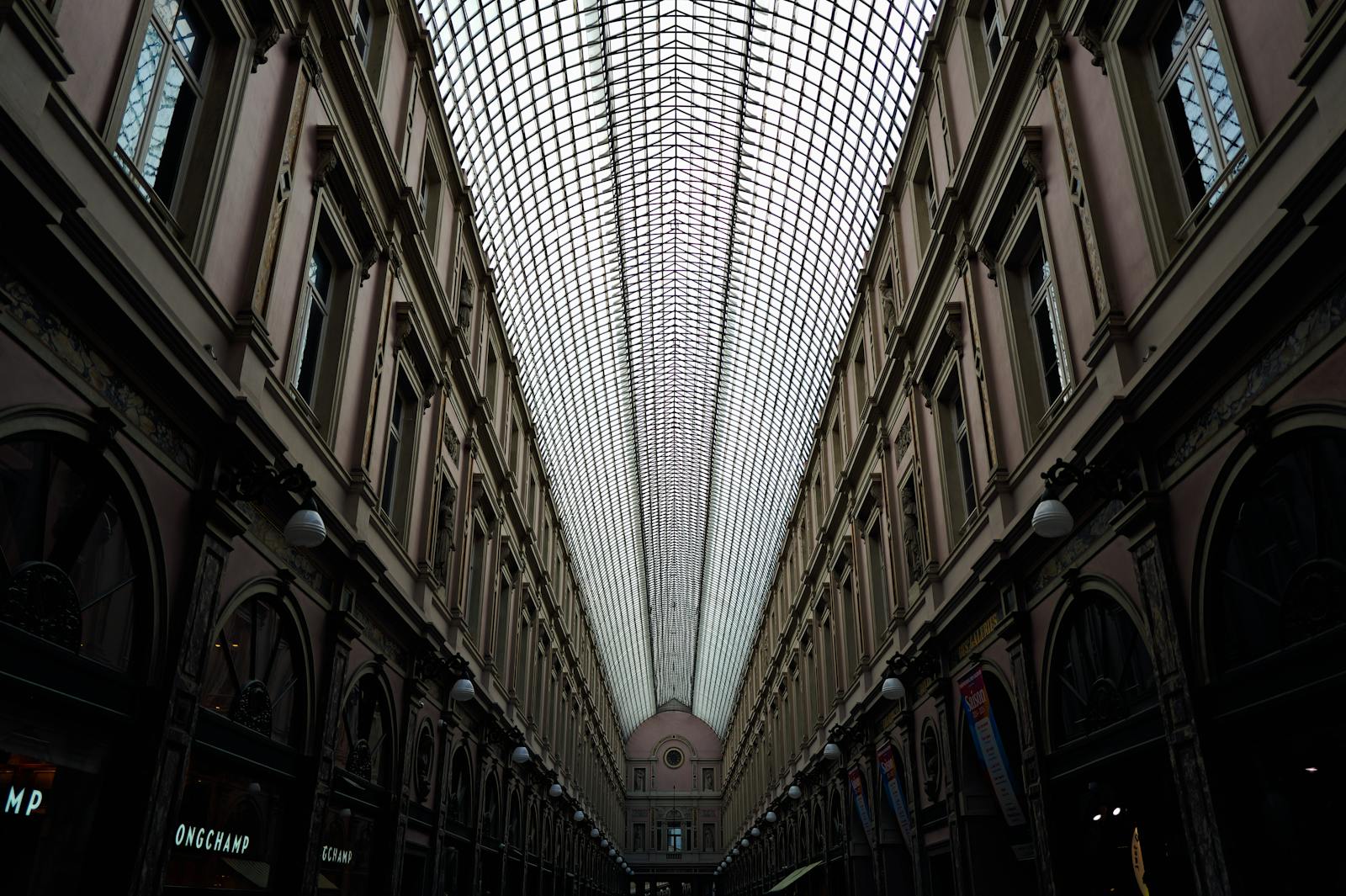 Galeries Royales Saint-Hubert guide — best detailed view of arched glass ceiling and ornate iron columns inside historic European shopping arcade