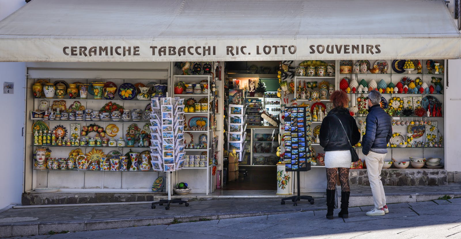 Best Belgian souvenirs Brussels — souvenir shop showcasing colorful ceramics postcards and authentic gifts