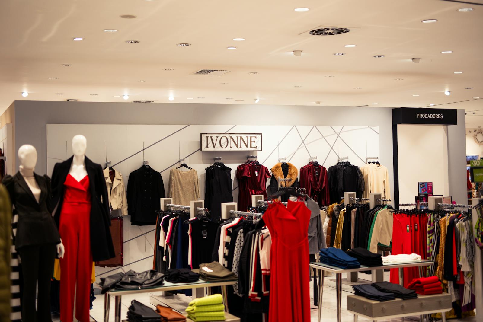 Brussels fashion designers shops — stylish fashion boutique displaying elegant clothing on mannequins under bright lights