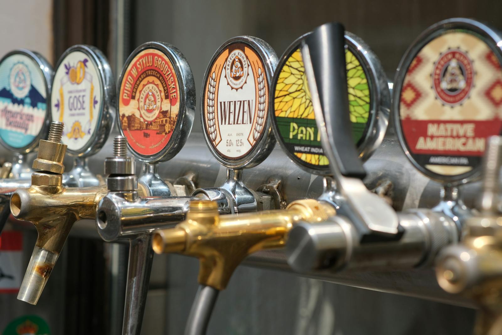 Craft beer bars Brussels — close-up of craft beer taps with diverse labels in Brussels bar setting