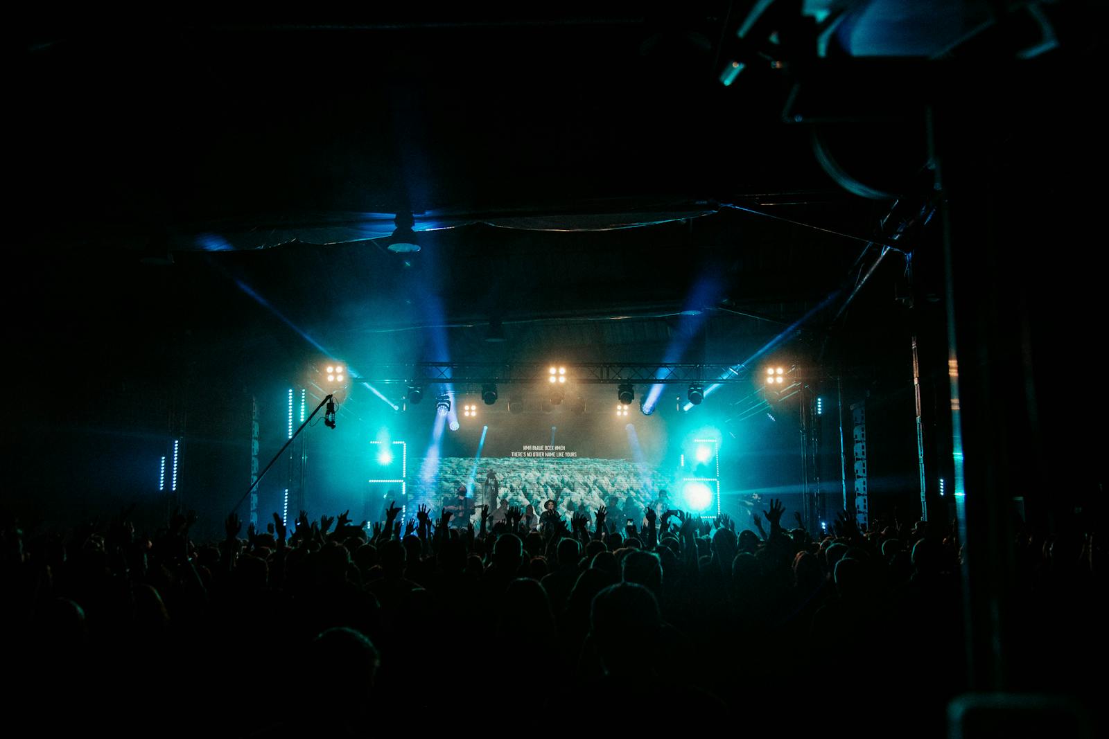 Live music venues Brussels — energetic concert crowd enjoying live music with dazzling stage lights