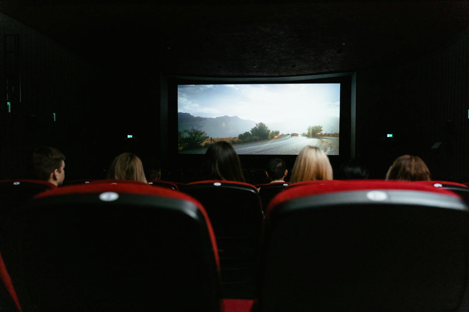 Brussels cinema film — best contemporary cinema theatre with audience watching movie screen in Brussels cinema venue