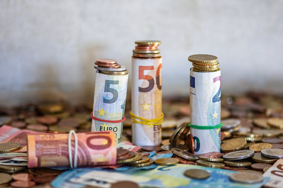 Brussels on a budget — best close-up of rolled Euro banknotes and coins symbolizing finance and budget travel