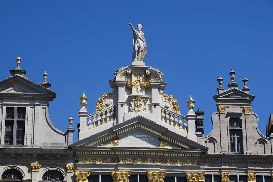 1 day in Brussels itinerary — best statue and ornate building facade in Brussels Grand Place under blue sky