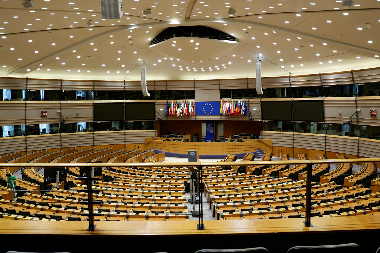 Brussels European Union capital — best European Parliament hemicycle chamber with rows of seats and EU flags