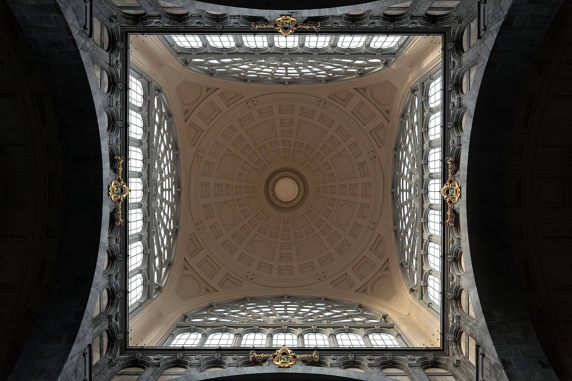 The coffered stone dome above the main hall of Antwerpen-Centraal railway station seen from directly below