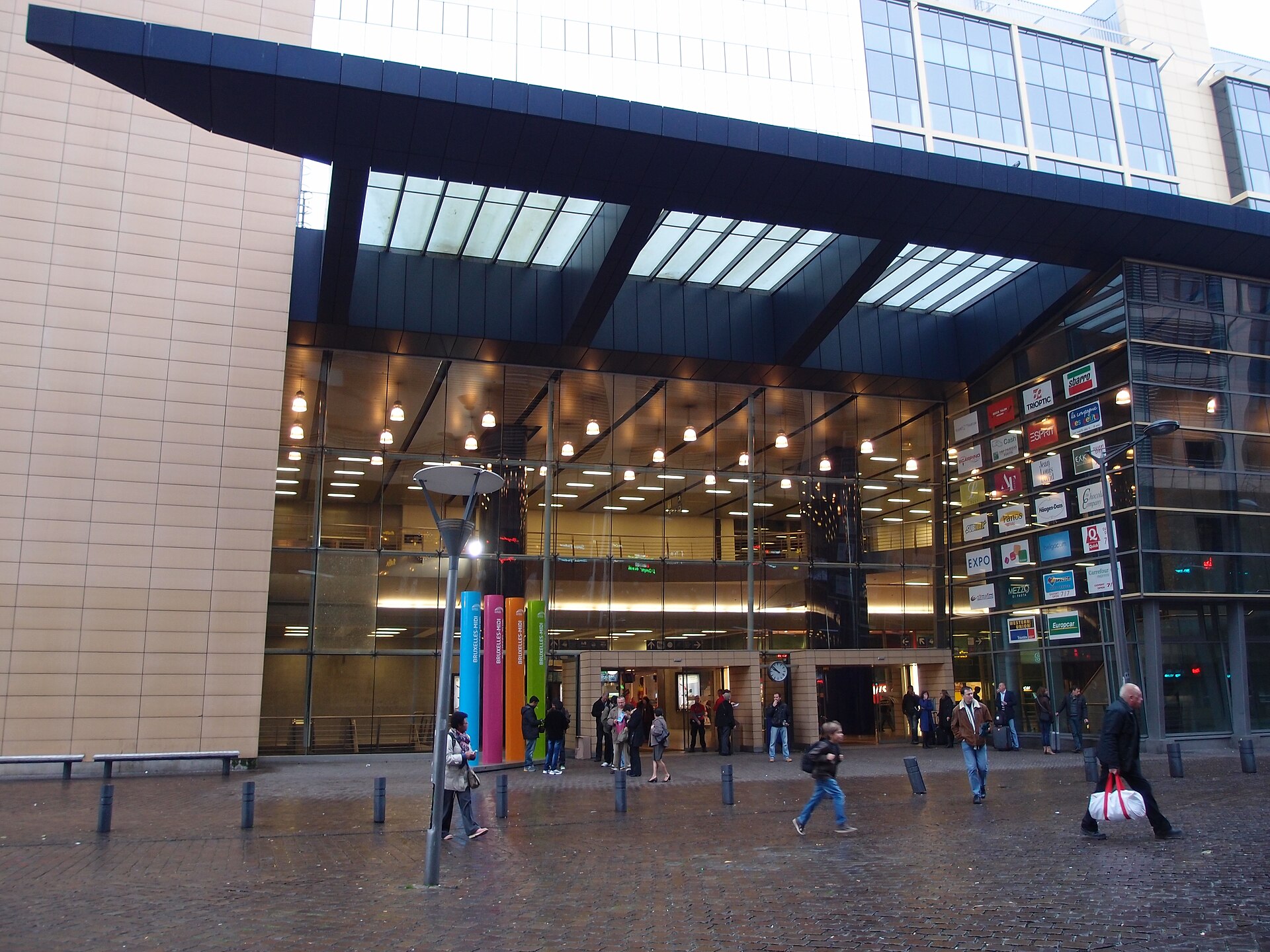The main entrance to Bruxelles-Midi station in Brussels with people crossing the square outside