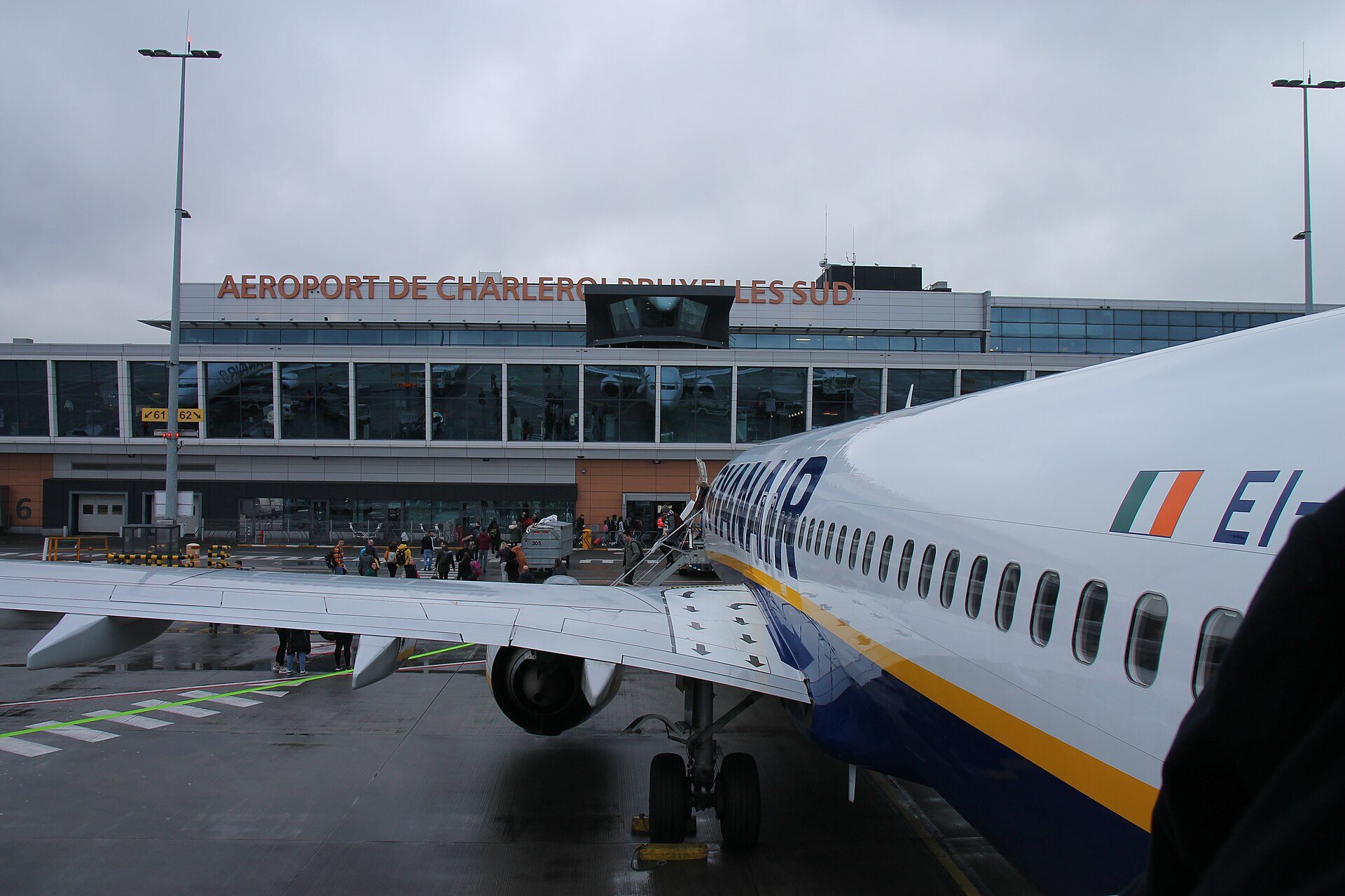 Passengers walking across the apron to a Ryanair aircraft at Charleroi Brussels South Airport