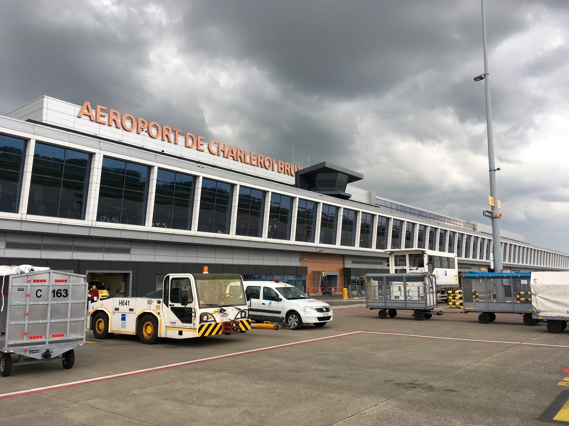 The exterior of Terminal 1 at Charleroi Brussels South Airport with orange lettering on the facade