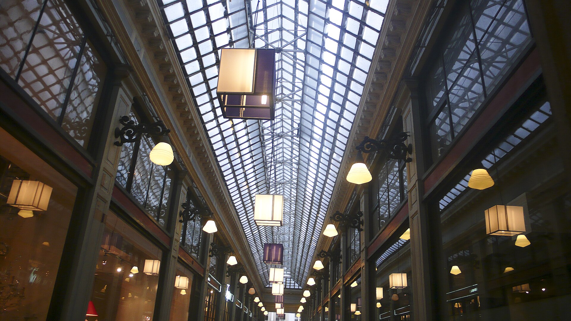 The glass roof and hanging lamps of the Galeries Royales Saint-Hubert arcade in Brussels