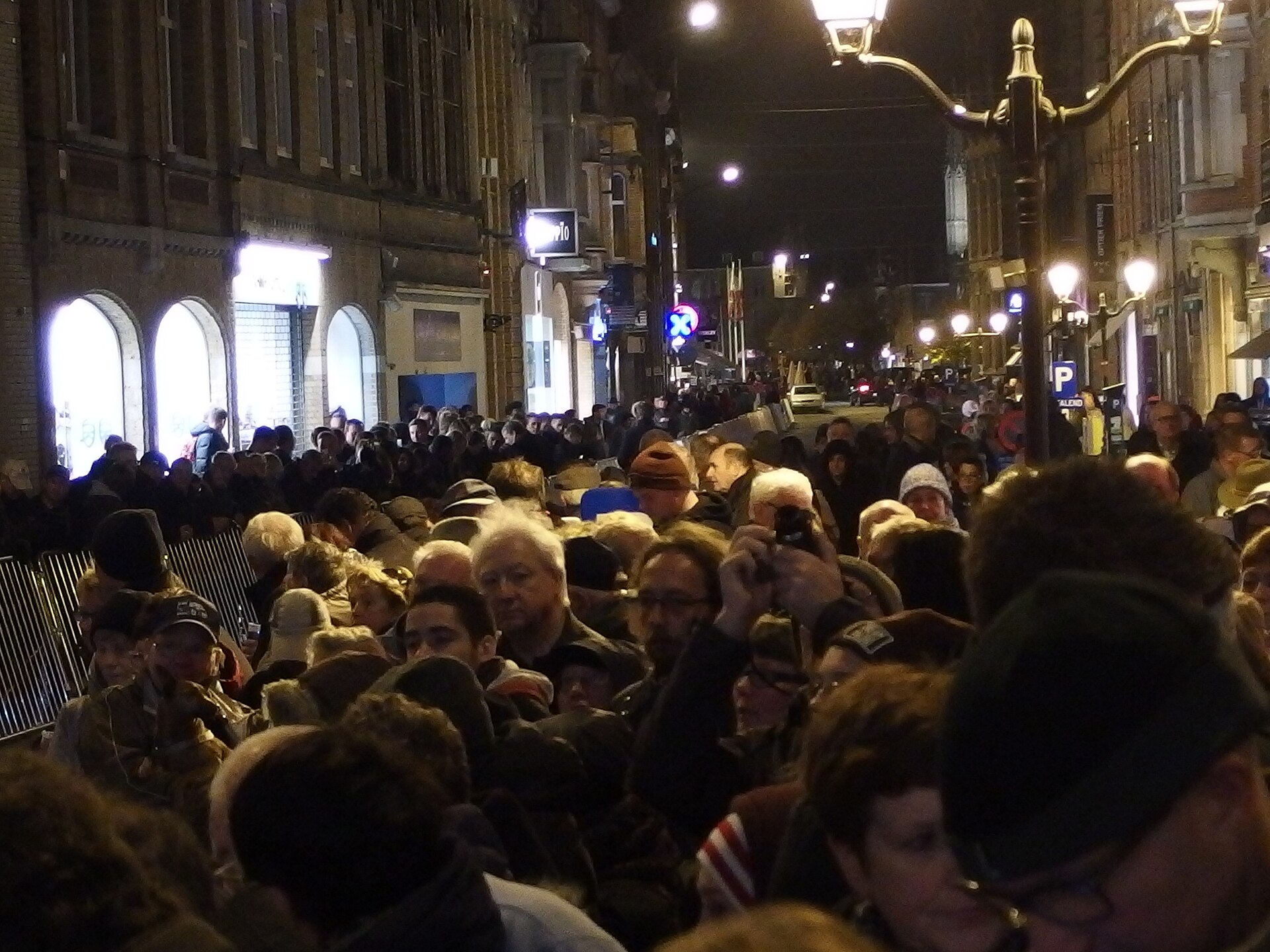 A dense evening crowd gathered in the street by the Menin Gate in Ypres for the Last Post ceremony
