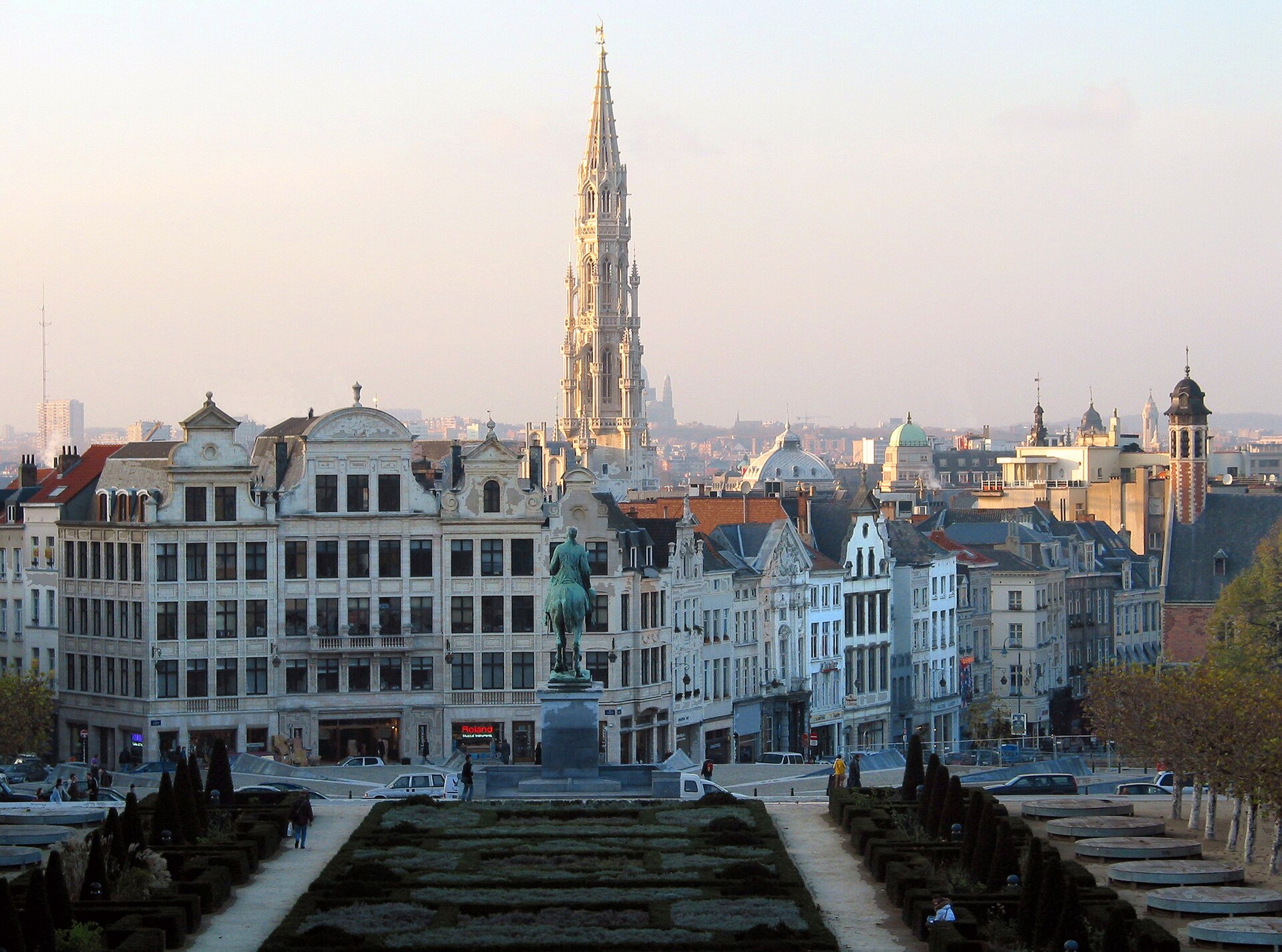 The view over Brussels rooftops from the Mont des Arts in low winter light with the town hall spire in the distance
