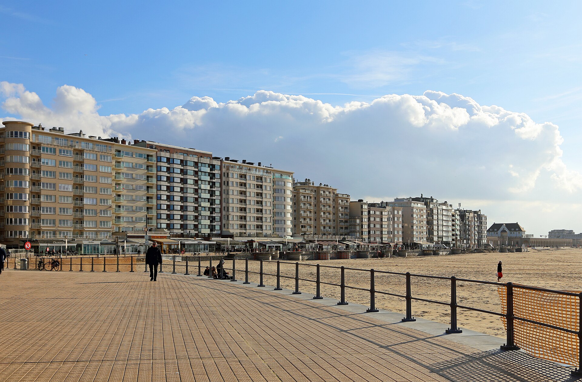 The Albert I promenade at Ostend, a wide boardwalk beside the beach with a line of apartment blocks along the seafront