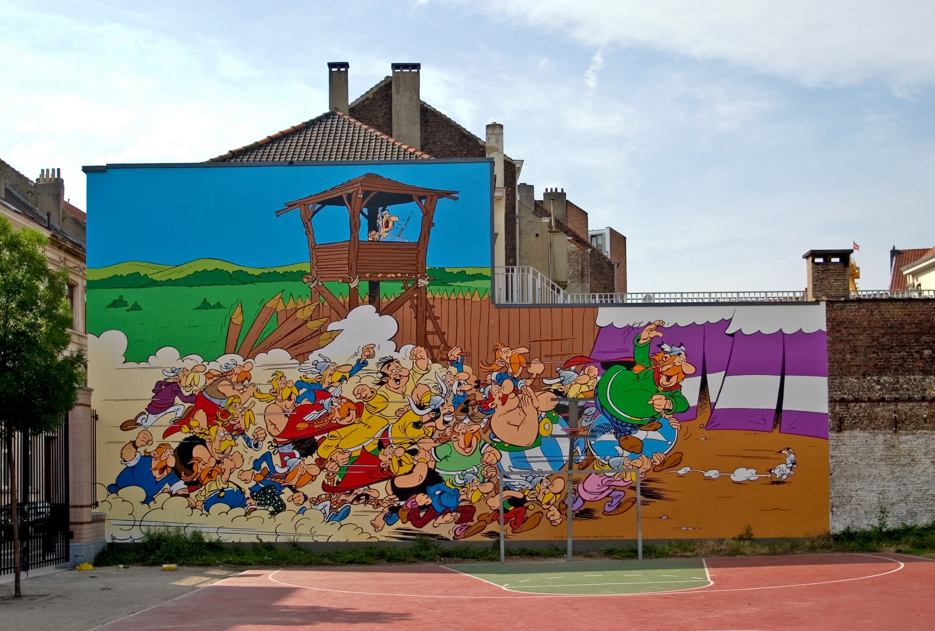 Asterix, Obelix and their fellow Gauls fill a colorful mural beside a sports court on Rue de la Buanderie, Brussels.