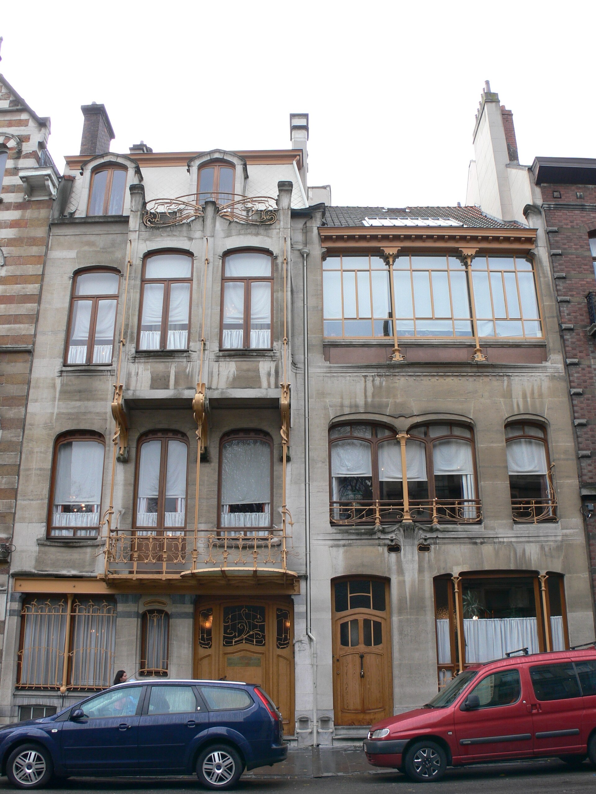 The Horta Museum in Brussels displays a projecting window bay, curved iron balcony and adjoining studio with broad upper windows.