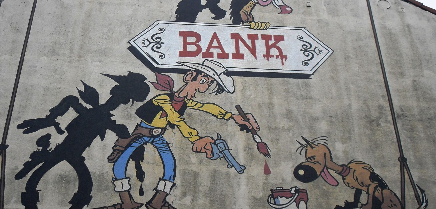 Lucky Luke paints a bank sign beside his shadow and a dog in a Brussels Comic Strip Trail mural.