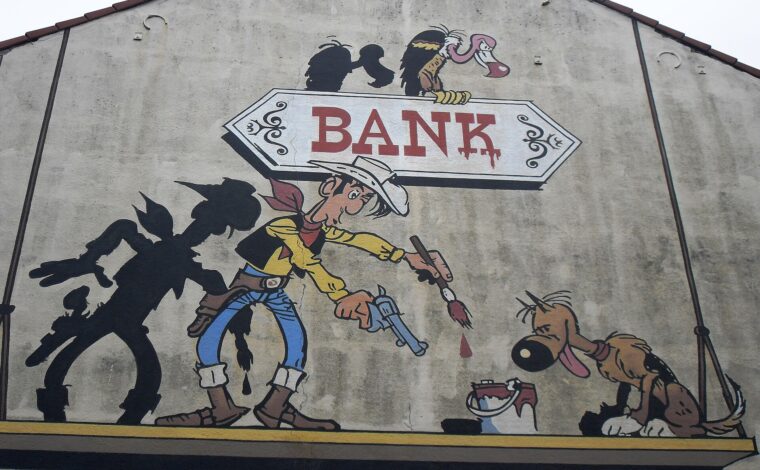 Lucky Luke paints a bank sign beside his shadow and a dog in a Brussels Comic Strip Trail mural.