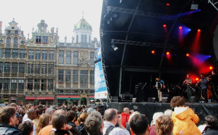 Musicians perform beside Brussels' Grand-Place guildhalls as a crowd watches the outdoor Jazz Marathon stage.
