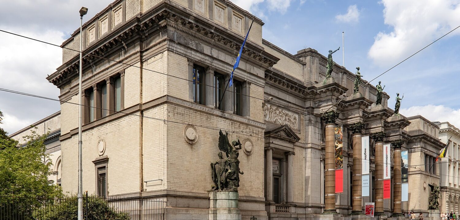 Royal Museums of Fine Arts of Belgium in Brussels, with bronze sculptures, entrance banners and tram tracks along the facade.